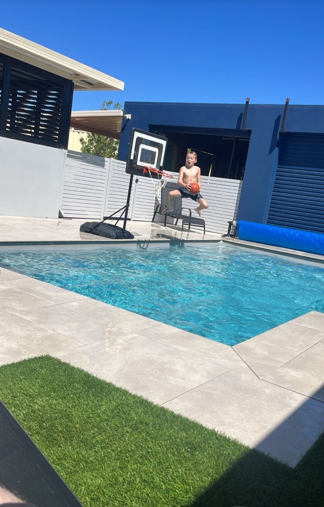 Pool surround paving with turf edge, Perth backyard
